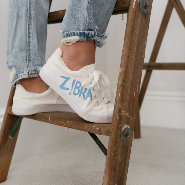 shoe with zibra painted in blue on it