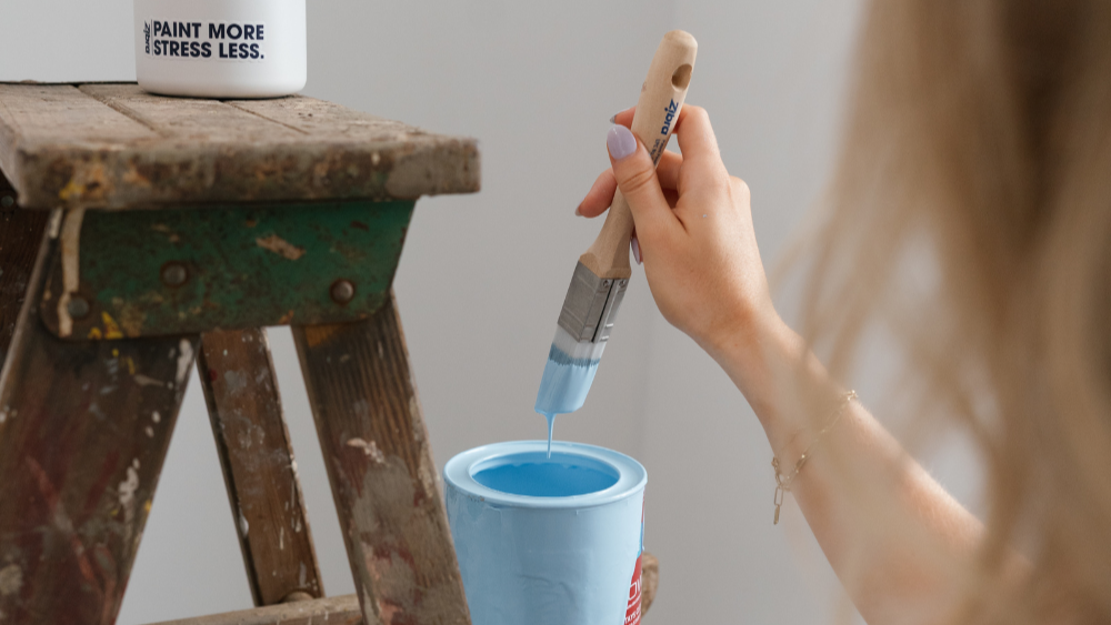 brush dipping into paint