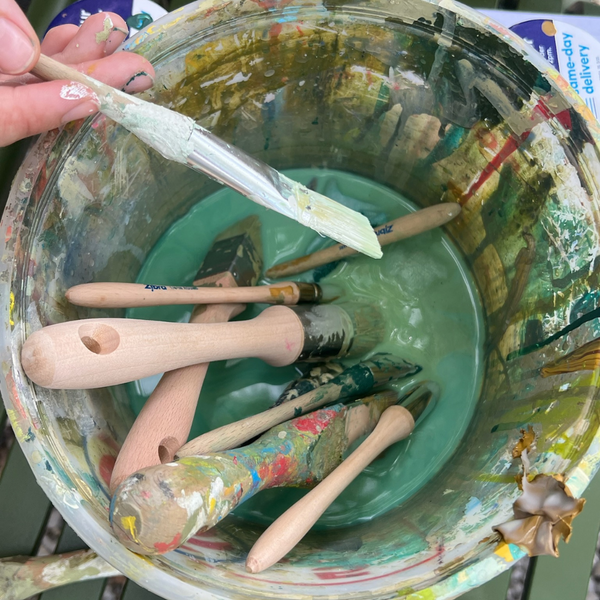 paint brushes soaking in bucket